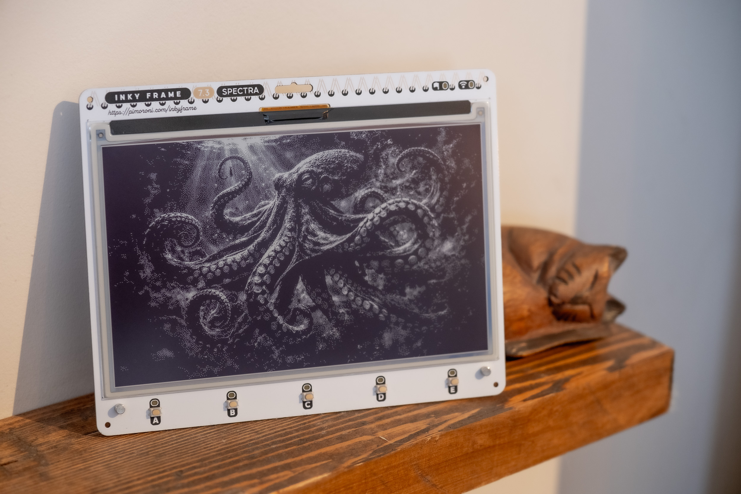 A black and white photograph displayed on an Inky Frame in a wooden picture frame